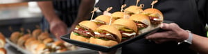 Lady holding tray of sliders