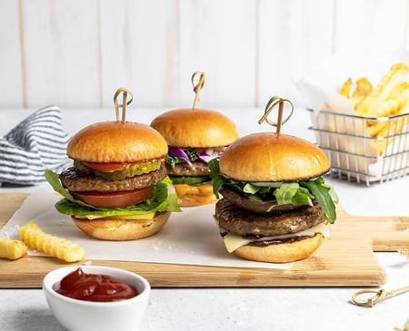 Three burgers and tomato sauce