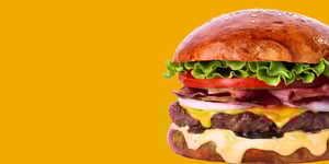 Angel Bay beef burger on yellow background.
