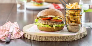 Angel Bay beef burger with fries on a serving board.